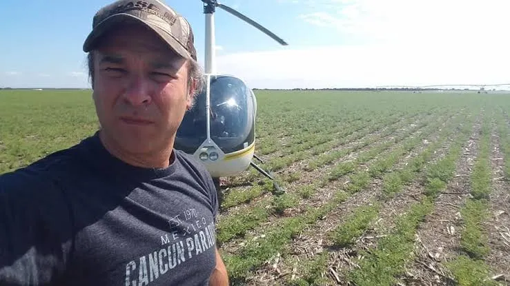 Mario Baldo junto a su helicóptero en el campo, en el norte de Córdoba.